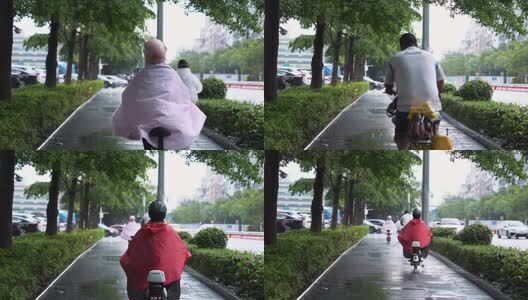 下雨天骑电动车的人高清在线视频素材下载