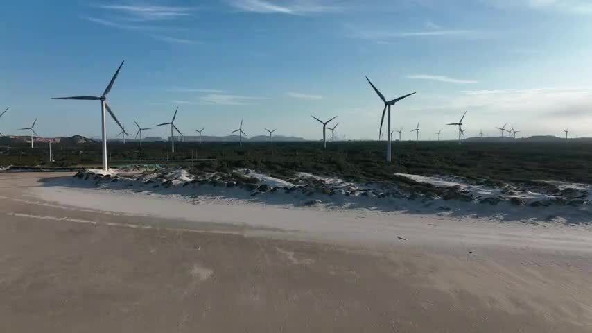 航拍福建平潭岛海滩风力发电机