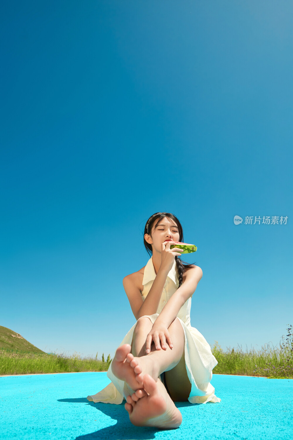 夏日户外湖边彩色公路上玩耍吃西瓜的少女