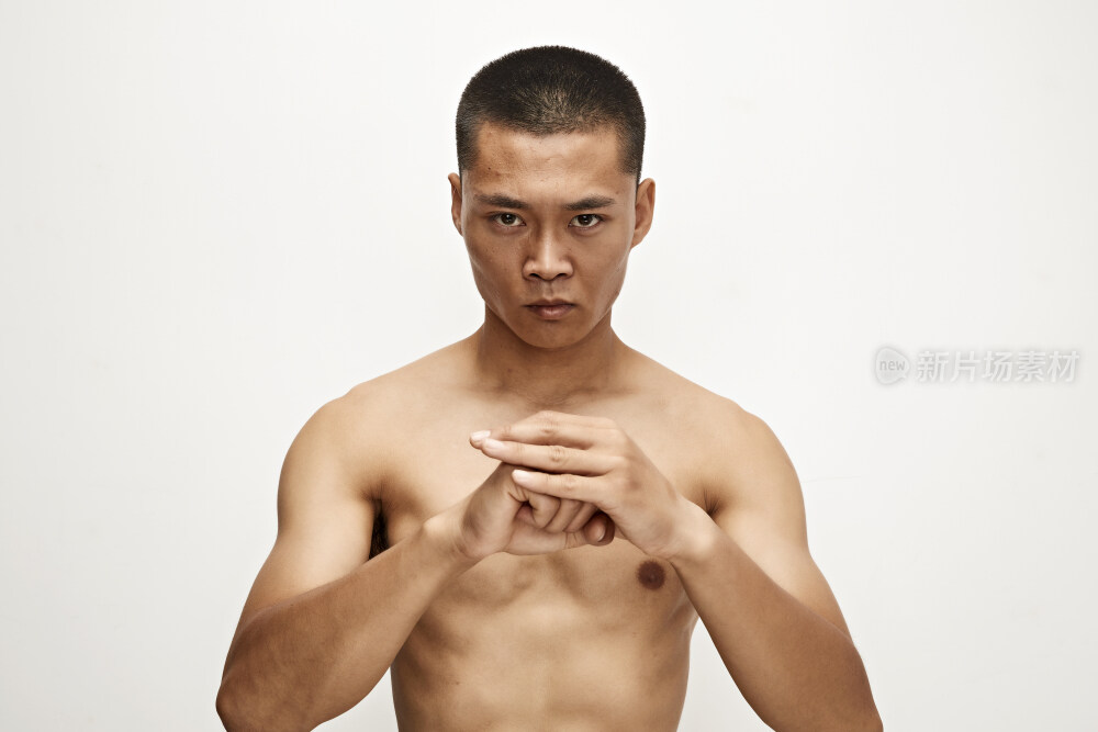 白色背景下演示自由搏击动作的亚洲功夫男性